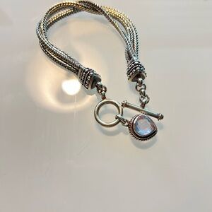 Intricate Silver Braided Bracelet with Iridescent Charm